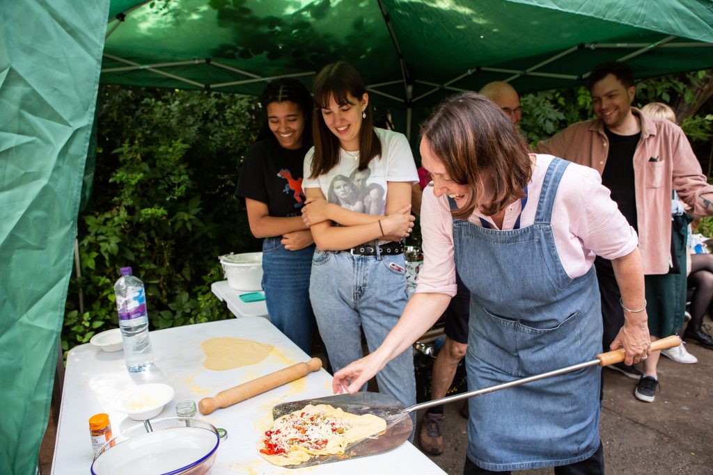 Staff tend the Mud Oven pizza making table.