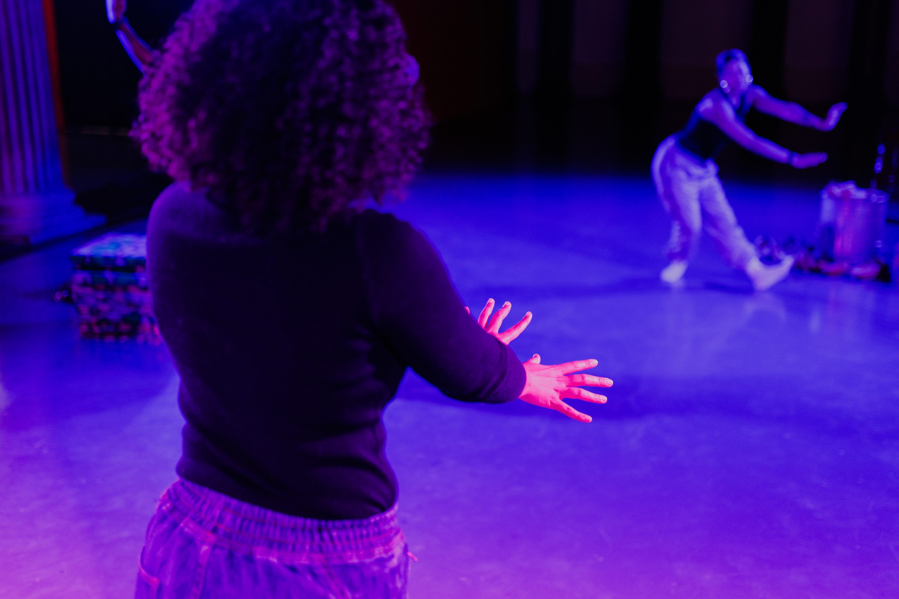 Two figures dance with each other