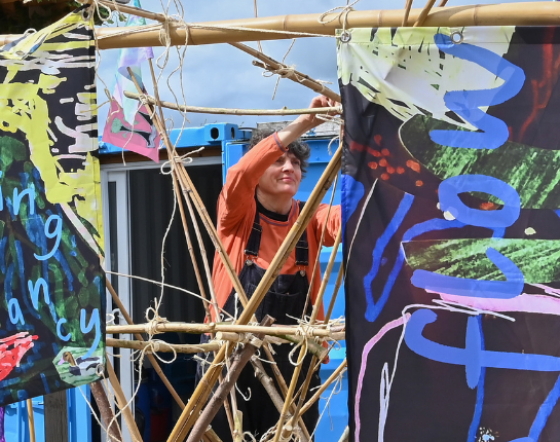 Artist Sarah Kenchington hangs sails by Peter and Rossi.