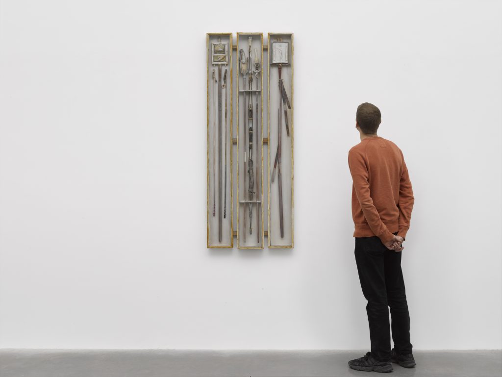 Visitor looks at piece of work on Wall by Will Maclean.