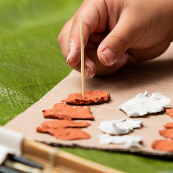 Young artist sculpts clay shapes.
