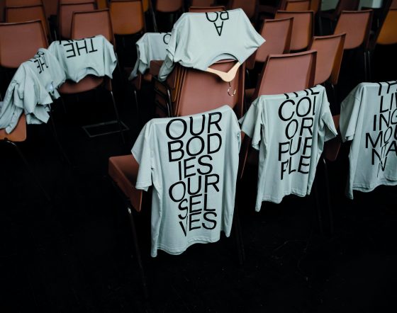 T-shirts are draped over chairs.